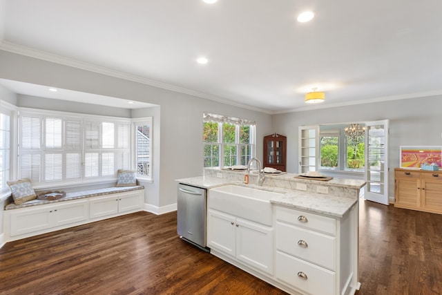 kitchen featuring light stone counters, dishwasher, a sink, and dark wood finished floors