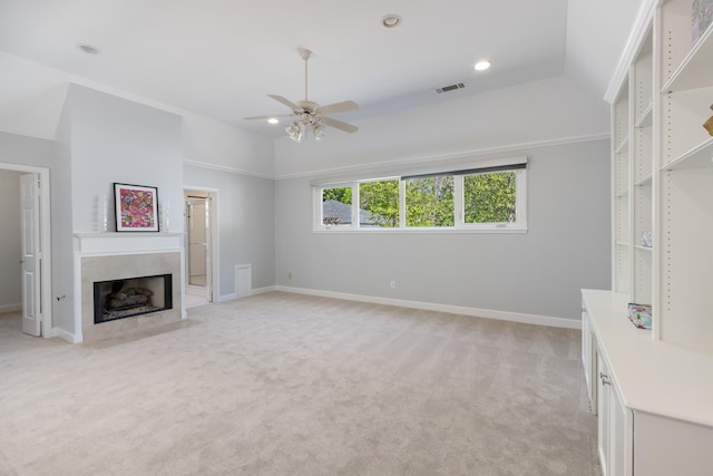 unfurnished living room featuring ceiling fan, light colored carpet, and lofted ceiling