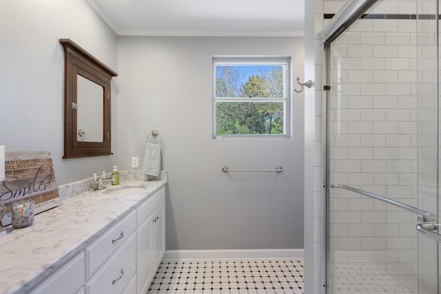 bathroom featuring a shower stall, vanity, baseboards, and crown molding