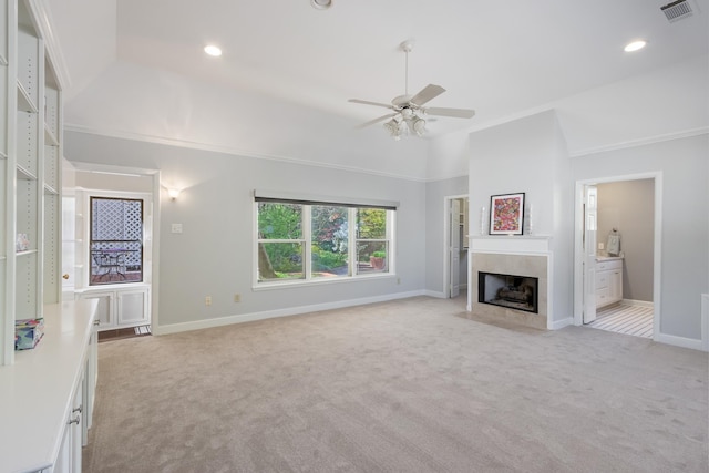 unfurnished living room with visible vents, baseboards, ceiling fan, a premium fireplace, and light carpet