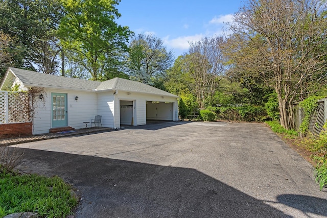 view of front facade with aphalt driveway and an attached garage