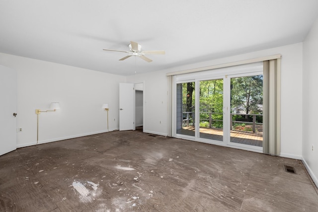 unfurnished room featuring ceiling fan and baseboards