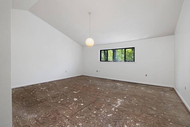 spare room with vaulted ceiling and baseboards
