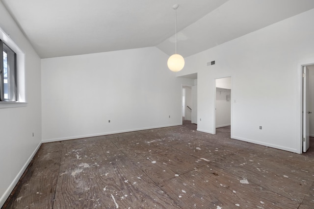 unfurnished living room featuring lofted ceiling and baseboards