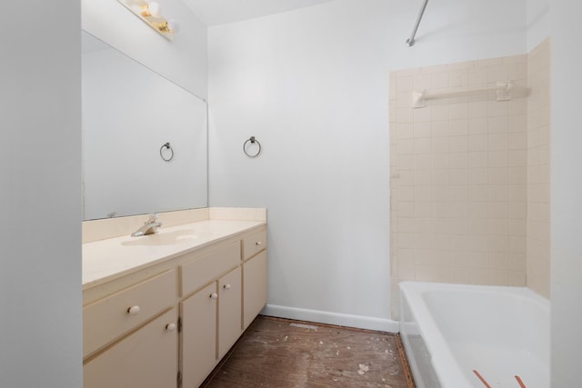 full bathroom with wood finished floors, vanity, baseboards, and bathing tub / shower combination