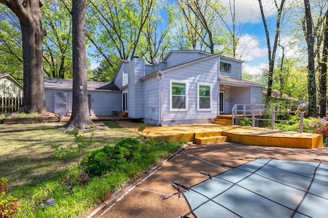 back of property featuring a chimney, a deck, crawl space, and a patio