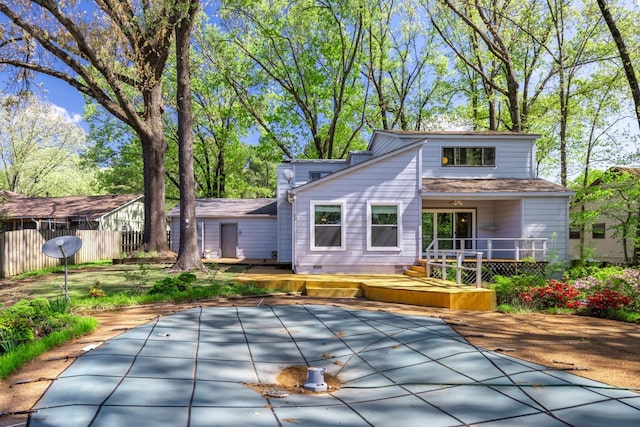 rear view of house featuring fence, a wooden deck, and crawl space