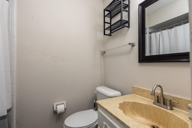 bathroom featuring vanity, a shower with curtain, and toilet