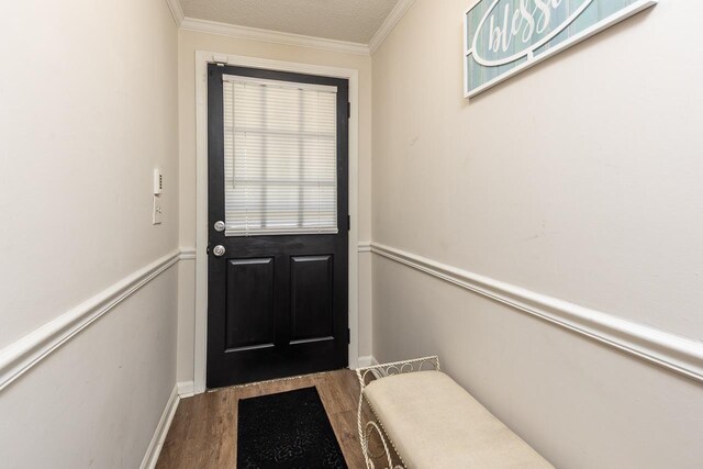 doorway with crown molding and wood finished floors