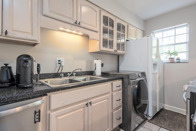 5718 Quince Rd Unit 4, Memphis, TN 38119 - laundry room with a sink, baseboards, washer / dryer, and tile patterned flooring