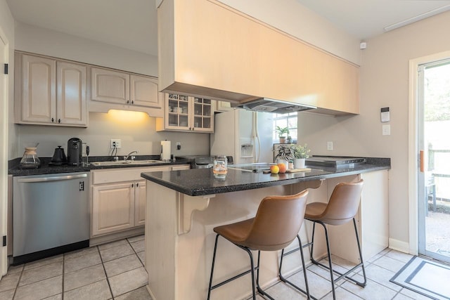 5718 Quince Rd Unit 4, Memphis, TN 38119 - kitchen with glass insert cabinets, white refrigerator with ice dispenser, a breakfast bar area, stainless steel dishwasher, and a sink