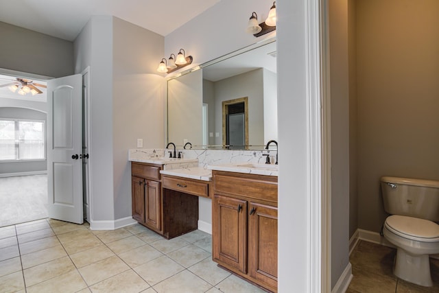 full bathroom with tile patterned floors, double vanity, ceiling fan, and a sink