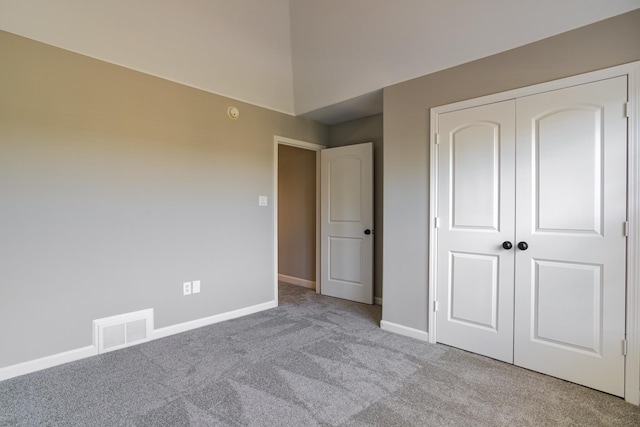 unfurnished bedroom featuring visible vents, baseboards, a closet, and carpet
