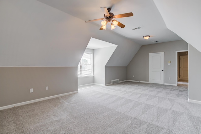 bonus room featuring light colored carpet, ceiling fan, lofted ceiling, and visible vents
