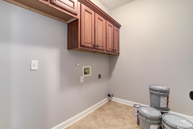 laundry area with light tile patterned floors, hookup for a washing machine, hookup for an electric dryer, baseboards, and cabinet space