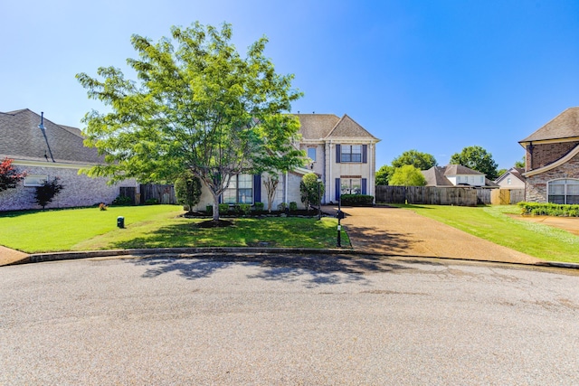 view of front of house featuring a front yard and fence