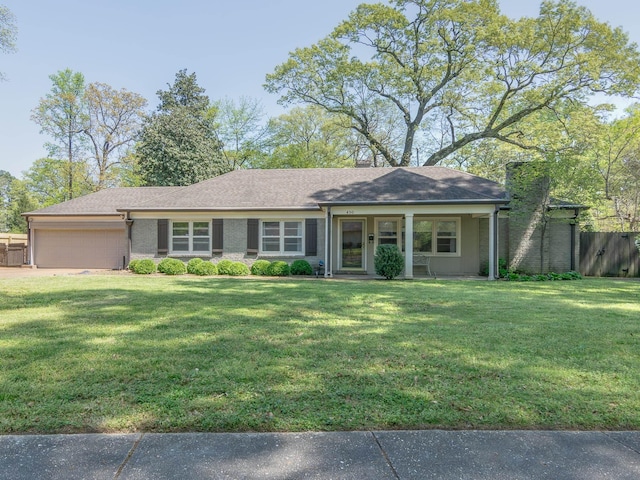 ranch-style house with fence, a garage, a front lawn, and a chimney