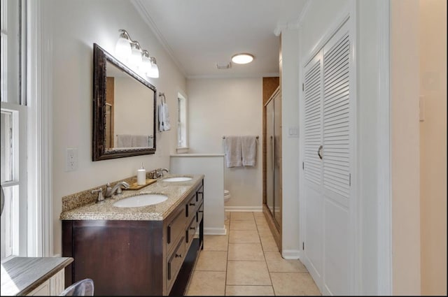 bathroom with toilet, tile patterned flooring, a closet, and a sink