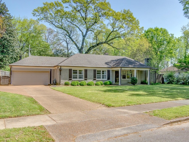 single story home featuring an attached garage, concrete driveway, fence, and a front yard