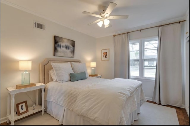 bedroom with baseboards, ceiling fan, crown molding, and visible vents