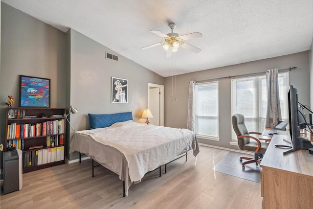433 S Perkins Dr Unit 433, Memphis, TN 38117 - bedroom with light wood-type flooring, vaulted ceiling, baseboards, a textured ceiling, and visible vents