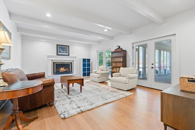 6555 Oak Estates Dr, Memphis, TN 38119 - living room featuring french doors, light wood finished floors, beam ceiling, and a high end fireplace