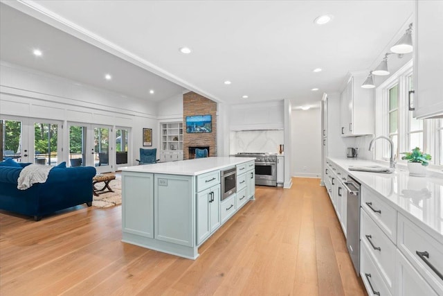 6555 Oak Estates Dr, Memphis, TN 38119 - kitchen featuring stainless steel appliances, open floor plan, french doors, and light countertops