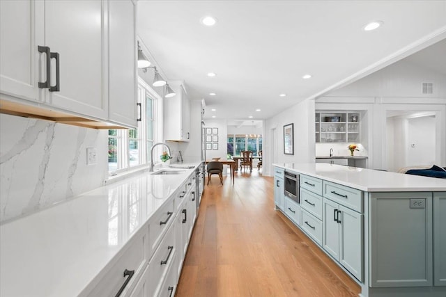 6555 Oak Estates Dr, Memphis, TN 38119 - kitchen featuring a sink, light countertops, light wood finished floors, and recessed lighting