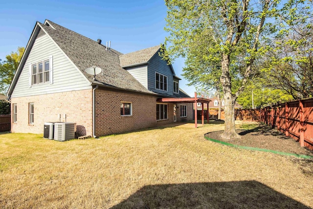 979 Welbeck Cv, Collierville, TN 38017 - back of house with a yard, a fenced backyard, central AC unit, and brick siding