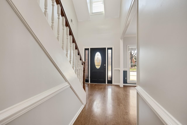979 Welbeck Cv, Collierville, TN 38017 - foyer featuring visible vents, wood finished floors, a towering ceiling, and stairs