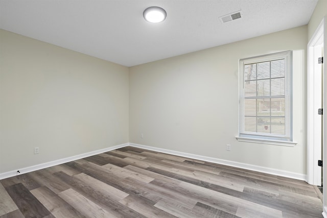 1098 Capital Ave, Memphis, TN 38107 - unfurnished room with visible vents, baseboards, and wood finished floors