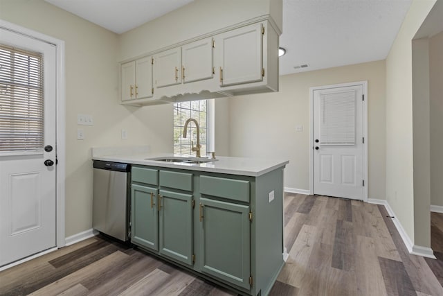 1098 Capital Ave, Memphis, TN 38107 - kitchen featuring dark wood finished floors, a peninsula, dishwasher, a sink, and green cabinetry