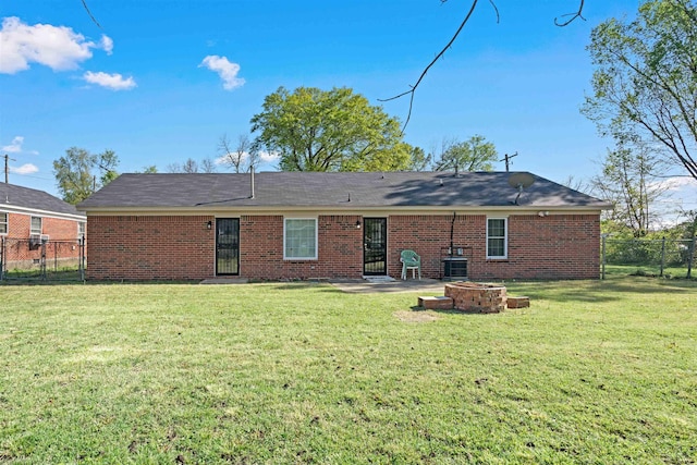 1098 Capital Ave, Memphis, TN 38107 - back of house featuring a yard, fence, a fire pit, and brick siding