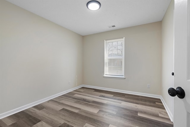 1098 Capital Ave, Memphis, TN 38107 - empty room featuring visible vents, baseboards, and wood finished floors