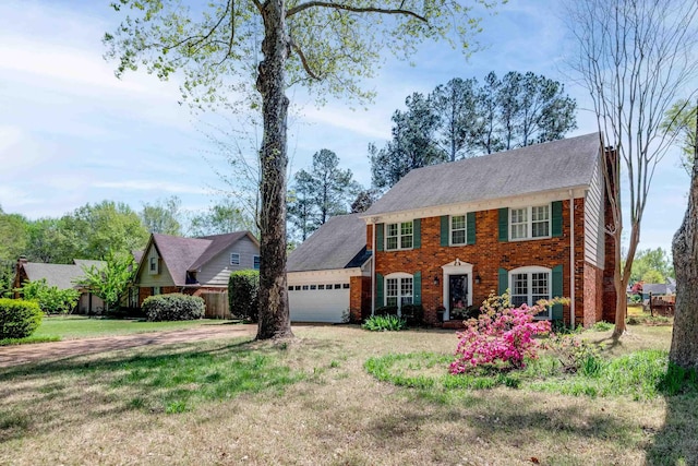 7545 Wheatley Dr, Germantown, TN 38138 - colonial inspired home featuring brick siding, driveway, a front lawn, and a garage