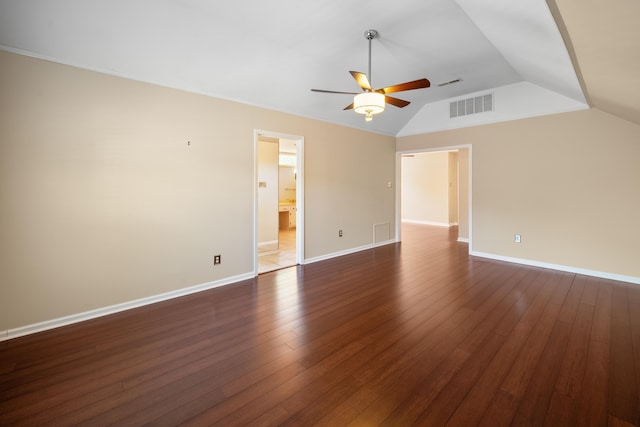 7545 Wheatley Dr, Germantown, TN 38138 - spare room featuring visible vents, baseboards, dark wood-style flooring, a ceiling fan, and vaulted ceiling