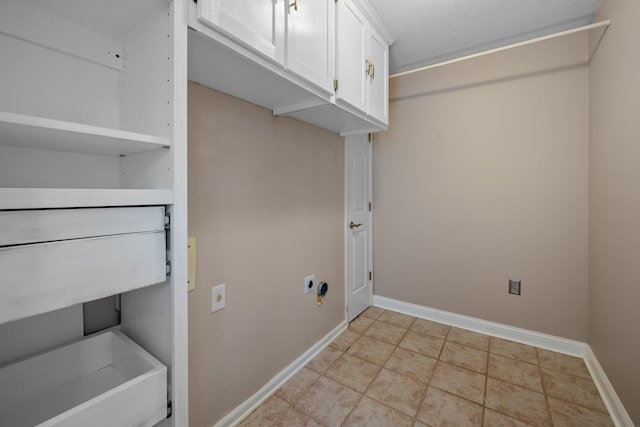 7545 Wheatley Dr, Germantown, TN 38138 - laundry area with electric dryer hookup, baseboards, and cabinet space