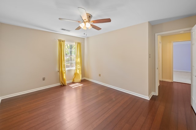 7545 Wheatley Dr, Germantown, TN 38138 - unfurnished room featuring dark wood-style floors, visible vents, baseboards, and ceiling fan