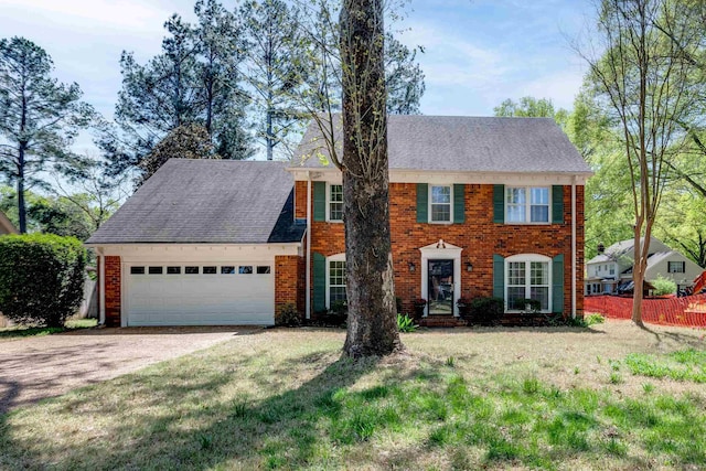 7545 Wheatley Dr, Germantown, TN 38138 - colonial inspired home featuring roof with shingles, fence, a front lawn, an attached garage, and driveway