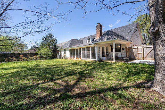 8453 Farrah Ln, Germantown, TN 38139 - rear view of house featuring a yard, a fenced backyard, a sunroom, and a chimney