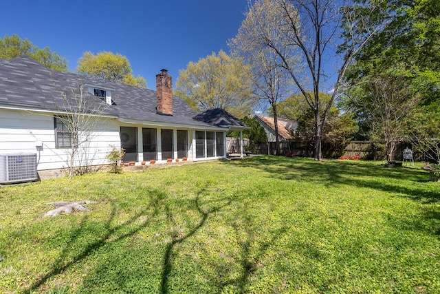 8453 Farrah Ln, Germantown, TN 38139 - back of house featuring fence, a yard, central air condition unit, and a sunroom