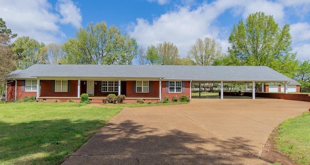 view of front facade with driveway, a front lawn, and brick siding