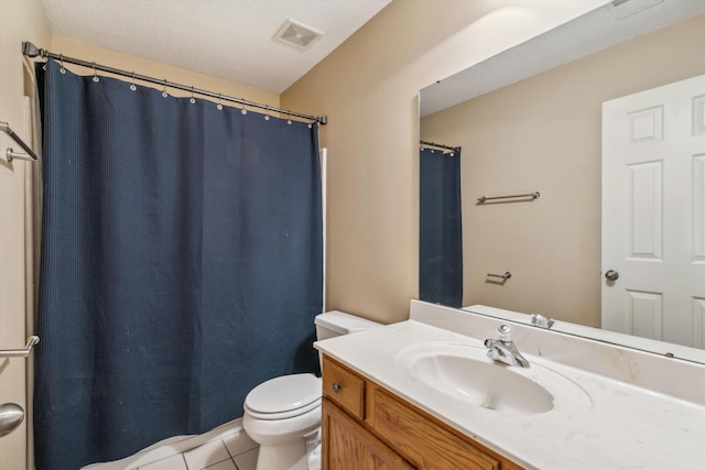bathroom with vanity, a shower with curtain, visible vents, toilet, and tile patterned floors