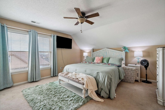 bedroom with light carpet, visible vents, baseboards, and a textured ceiling