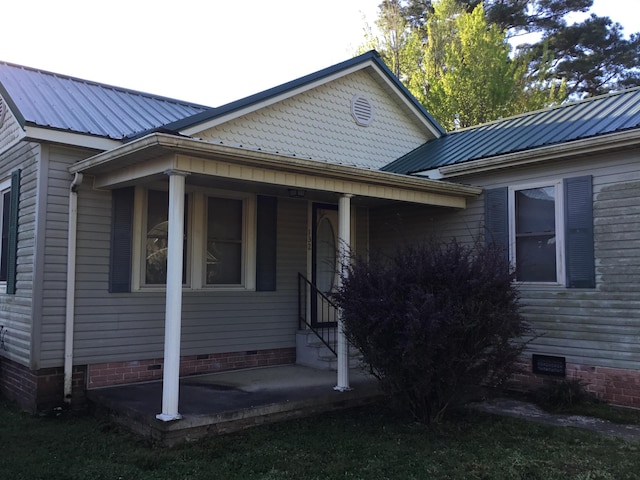 view of front facade with crawl space and metal roof