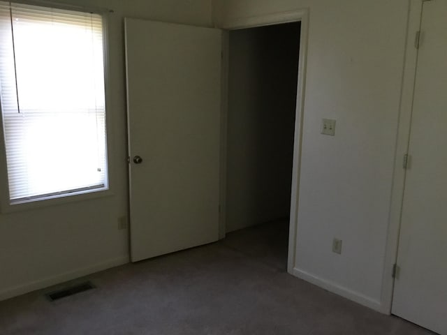 empty room with light carpet, baseboards, and visible vents