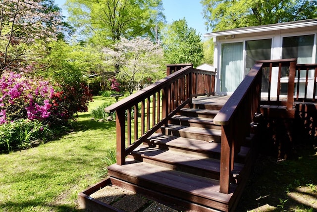 wooden deck featuring stairway and a lawn