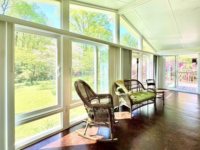sunroom / solarium featuring lofted ceiling with beams