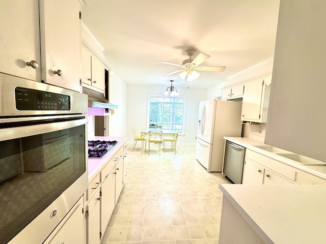 kitchen with appliances with stainless steel finishes, light countertops, a ceiling fan, white cabinetry, and under cabinet range hood