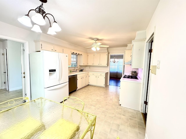 kitchen with stainless steel dishwasher, light countertops, ceiling fan with notable chandelier, a wealth of natural light, and white fridge with ice dispenser